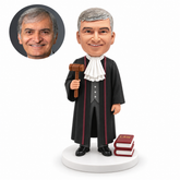 custom bobblehead figure male judge holding a gavel beside two law books