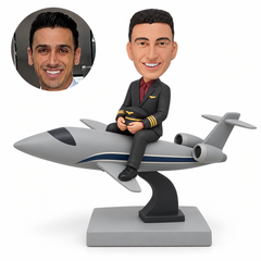 custom bobblehead figure male pilot seated astride a sleek jet airplane on a curved display stand