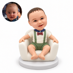 custom bobblehead figure baby sitting in an armchair with both hands resting on the armrests
