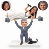 custom bobblehead figures kneeling groom lifting a bride on an overhead barbell with a fixed black cat