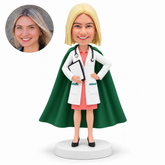 custom bobblehead figure female doctor with a long cape holding a clipboard against her waist and her other hand on her hip