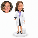 custom bobblehead figure female dentist holding a small mallet and a tooth beside a separate floor-standing molar model