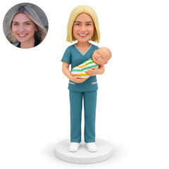 custom bobblehead figure female midwife in scrubs cradling one swaddled infant with both arms