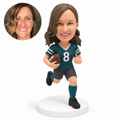custom bobblehead figure female rugby player running with a ball in her right arm and her left thumb up