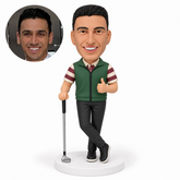 custom bobblehead figure male golfer with crossed ankles resting his right hand on an upright golf club and giving a left hand thumbs up