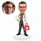 custom bobblehead figure male doctor standing with his right hand on his hip and holding a first-aid case in his left hand