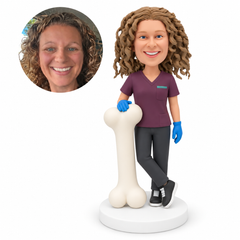 custom bobblehead figure female orthopedic doctor resting her right gloved hand on a large upright bone model with crossed ankles