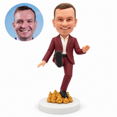 custom bobblehead figure man lifting one shoe forward while standing on sculpted poop ornaments