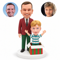 custom bobblehead figures father standing behind his son raising both arms from an open gift box