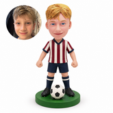 Boy soccer player with low fists and ball centered in front