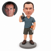 Custom male repairman bobblehead with drill at one shoulder and two tools at hip