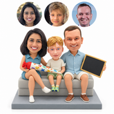 custom bobblehead figures mother father and son seated on a sofa with a school cone and a chalkboard