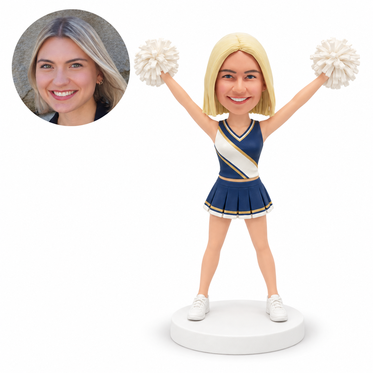 Custom female cheerleader clay bobblehead raising both white pom-poms in a high V pose, wearing a navy and gold uniform with matching portrait photo