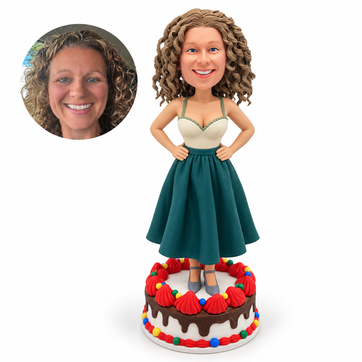 Custom soft-clay bobblehead woman with both hands on hips standing on a decorated cake display base, with matching real-photo portrait