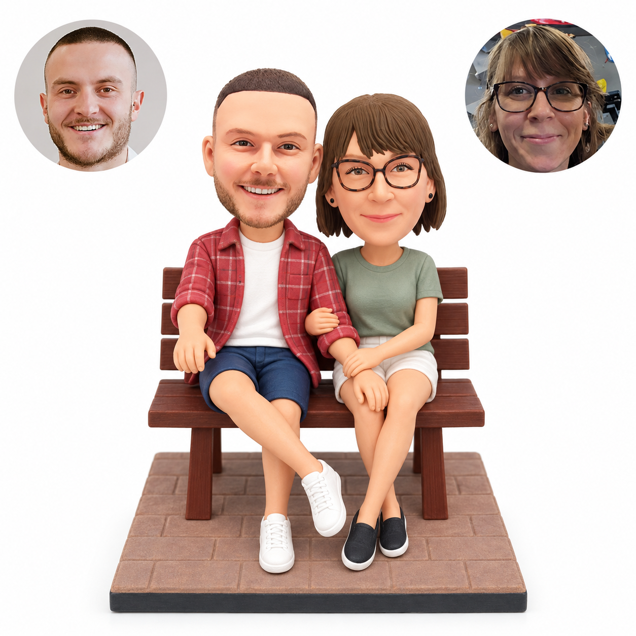 Custom clay couple bobbleheads seated on a slatted park bench, man with crossed leg and woman linking his arm, with matching real photo portraits.