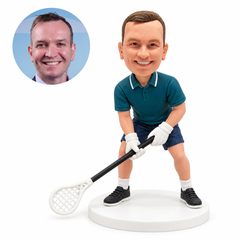 Custom male lacrosse bobblehead leaning forward, gripping a low diagonal stick with both white-gloved hands, with a matching real photo portrait.