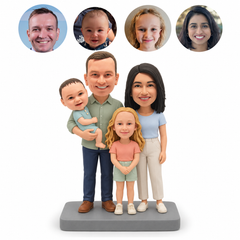 Four-person custom clay bobblehead: father holding a baby beside mother and young daughter, with four matching real-photo portrait circles and one gray base