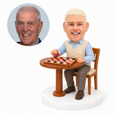 custom bobblehead figure older man playing checkers at a round table