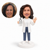 custom bobblehead figure female ophthalmologist holding an eye chart