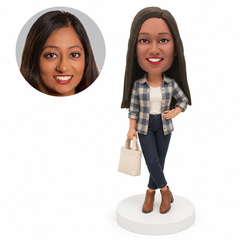 custom bobblehead figure woman in a plaid shirt carrying a tote bag