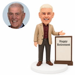 custom bobblehead figure retired man beside a retirement message board