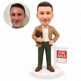 custom bobblehead figure real estate agent beside a for sale sign