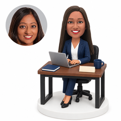 custom bobblehead figure businesswoman in a pantsuit working at a laptop