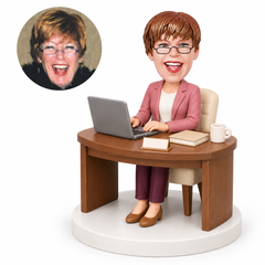 custom bobblehead figure businesswoman at a curved desk with a laptop
