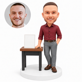 custom bobblehead figure businessman beside a display table
