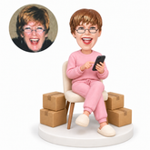 custom bobblehead figure woman checking her phone beside packages