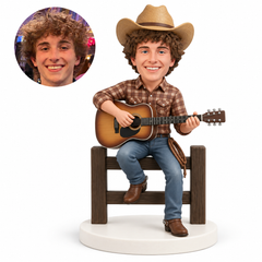 custom bobblehead figure cowboy playing an acoustic guitar on a wooden fence