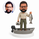 custom bobblehead figure fisherman with a tackle box and fish in a motorboat