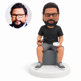 custom bobblehead figure seated man holding a pipe and ashtray