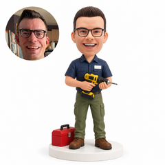 custom bobblehead figure mechanic holding a drill with both hands beside a toolbox