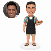 custom bobblehead figure man in an apron holding a burger platter