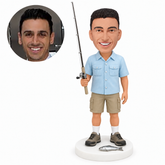 custom bobblehead figure fisherman holding a rod beside a fish