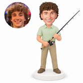 custom bobblehead figure man in a Polo shirt holding a fishing rod with both hands