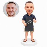 custom bobblehead figure man in an apron holding barbecue tongs and giving a thumbs up