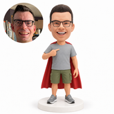 custom bobblehead figure man pointing to his T-shirt with cargo shorts and a cape