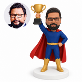 custom bobblehead figure man in a cape raising a trophy with one hand on his hip