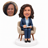 custom bobblehead figure female psychologist writing on a clipboard in an armchair