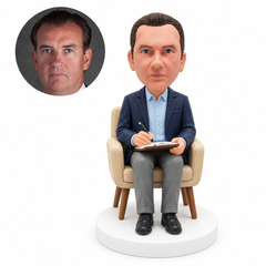 custom bobblehead figure male psychologist writing on a clipboard in an armchair