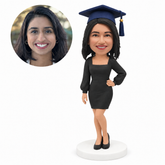 custom bobblehead figure female graduate in a long-sleeve fitted dress with one hand on her hip - custom polymer clay bobblehead figure
