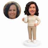 custom bobblehead figure woman in a crew-neck sweater holding a coffee mug with one hand on her hip