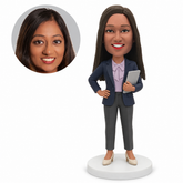 custom bobblehead figure woman in a blazer holding a tablet with one hand on her hip