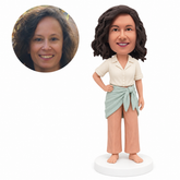 custom bobblehead figure woman in a collared shirt and sarong over trousers standing barefoot