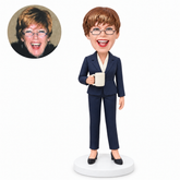 custom bobblehead figure woman in a pantsuit holding a coffee mug with her other arm relaxed