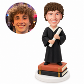 custom bobblehead figure male graduate standing on stacked books and holding a diploma