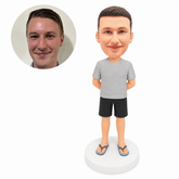 custom bobblehead figure man in a T-shirt and shorts with hands behind his back and flip-flops