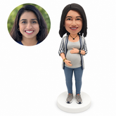 custom bobblehead figure pregnant woman in a cardigan and jeans cradling her belly